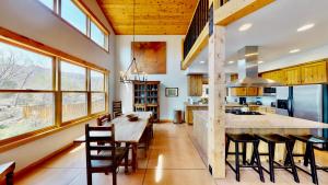 a kitchen with a large wooden table and chairs at Rim View Retreat #14 in Moab