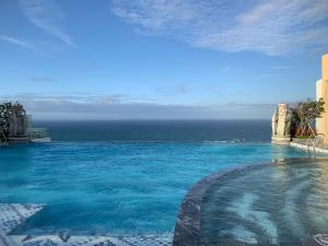 a swimming pool with a view of the ocean at Win Condotel Apec Phú Yên in Tuy Hoa