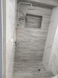 a shower in a bathroom with a tiled floor at Samana house in Santa Bárbara de Samaná