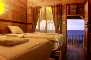 Llit o llits en una habitació de Malibu Huts