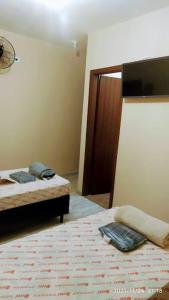 Postel nebo postele na pokoji v ubytování Hotel Palace Vila Sônia