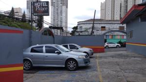 a couple of cars parked in a parking lot at Hotel Palace Vila Sônia in São Paulo