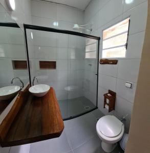 a bathroom with a sink and a toilet and a shower at Estância Canaã Atibaia in Atibaia