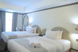 Voodi või voodid majutusasutuse Louis Kienne Hotel Pemuda toas