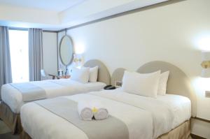 Voodi või voodid majutusasutuse Louis Kienne Hotel Pemuda toas