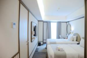 Voodi või voodid majutusasutuse Louis Kienne Hotel Pemuda toas
