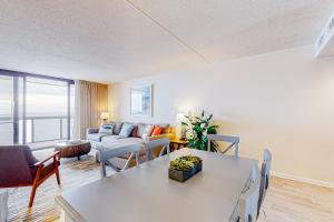a living room with a couch and a table at Golden Sands 1107 in Ocean City