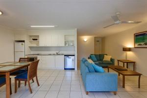 a kitchen and a living room with a table and chairs at Baden 74 Rainbow Shores in Rainbow Beach