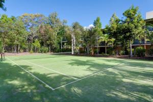 a tennis court in front of a building at Baden 74 Rainbow Shores in Rainbow Beach