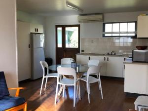 a kitchen and dining room with a table and chairs at 9 Indigo Avenue Rainbow Beach in Rainbow Beach