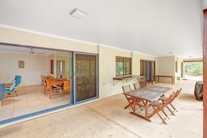 a living room with a table and chairs at 18 Naiad Court Rainbow Shores in Rainbow Beach