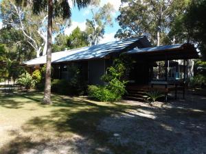 a house with a solar roof on top of it at 43 Satinwood Drive Rainbow Shores in Rainbow Beach
