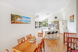 a kitchen and dining room with a table and chairs at 40 Rumbalara Avenue Rainbow Beach in Rainbow Beach