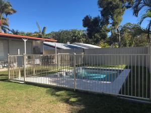 a fence around a swimming pool in a yard at 10 Coora Court Rainbow Beach in Rainbow Beach