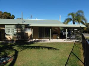 a house with a green roof and a yard at Palmgrove 1 Rainbow Beach in Rainbow Beach