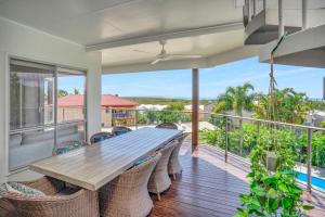 a table and chairs on a balcony with a view of the ocean at Rainbow Towers 2 Rainbow Beach in Rainbow Beach