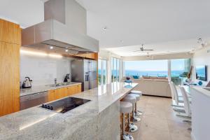 a kitchen with a counter top with a view of the ocean at Dees Retreat Rainbow Beach in Rainbow Beach