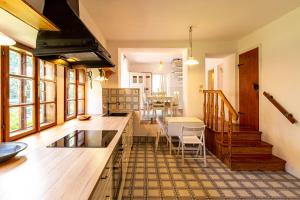 a kitchen and living room with a table and chairs at Weissenbacherhof in Oslip
