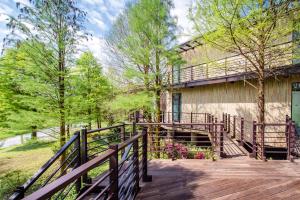 a wooden walkway leading to a building with trees at 灣曲時尚會館 Watch House in Dongshan