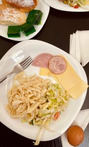 a white plate of food with pasta and meat at Abaash Hotel Afon in Novy Afon