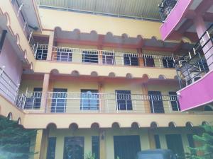 zewnętrzny widok na budynek z balkonami w obiekcie Sunshine Hotel w mieście Trikunamalaja