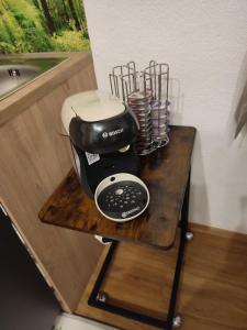 Studio in einem Bauernhaus في سانت ولفغانغ: آلة صنع القهوة على موقف خشبي على منضدة