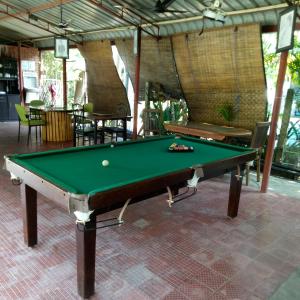 a pool table with a ball on top of it at Palms Villa in Negombo