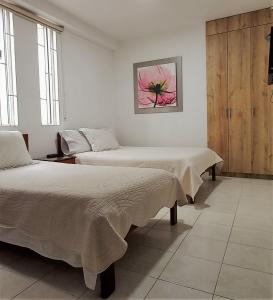 Un pat sau paturi într-o cameră la San Juan Del Lago