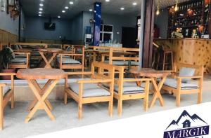 a group of tables and chairs in a restaurant at Margik Backpackers Hostel in Pokhara