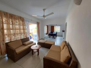 a living room with two couches and a table at Beau Vallon Villa Self Catering With Pool in Beau Vallon