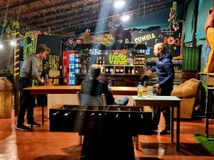 a group of people sitting at a bar at Valle verde, Hostel & camping in Urubamba