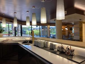 a kitchen with a counter with white dishes on it at Alevic Hotel Sirmione in Sirmione