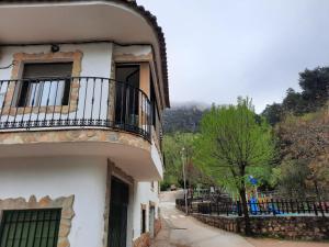 a building with a balcony on the side of it at Apartamentos El Portillo in Arroyo Frio