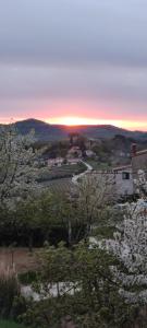 a sunset over a town with trees and houses at Apartman Tramonto in Motovun