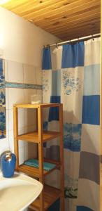 a bathroom with a sink and a shower curtain at Chalet mer et montagne in Sainte-Anne