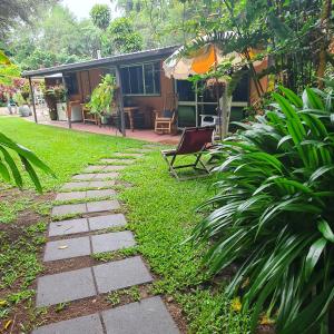 a garden with a stone path in front of a house at Garden Studio in Jaggan