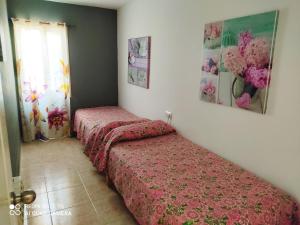 a bedroom with two beds and a window at Menorca beach in Cala Galdana