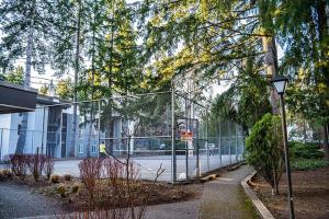 a chain link fence in front of a building at Condo with king bed, walk to Microsoft & park in Bellevue
