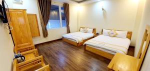 Giường trong phòng chung tại DALAMOON HOTEL