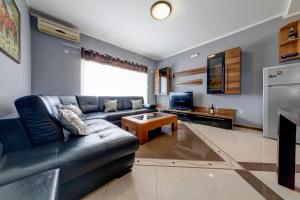 a living room with a couch and a table at Apartments Casa Bella in Kotor +19 photos