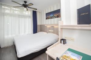 Ένα ή περισσότερα κρεβάτια σε δωμάτιο στο Hotel Breitner