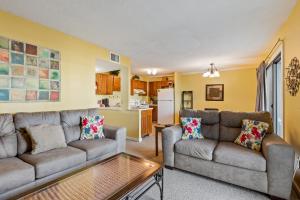 a living room with two couches and a kitchen at Myrtle Beach Resort -B-229 in Myrtle Beach