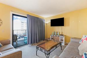 a living room with a couch and a flat screen tv at Myrtle Beach Resort -B-229 in Myrtle Beach