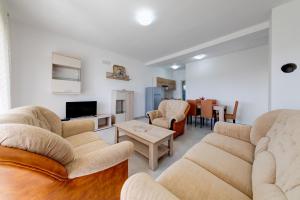 - un salon avec des canapés, une télévision et une table dans l'établissement Apartments Casa Bella, à Kotor