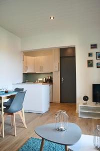 a living room and kitchen with a table and chairs at Domaine La Castilha in Biscarrosse