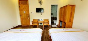 Giường trong phòng chung tại DALAMOON HOTEL