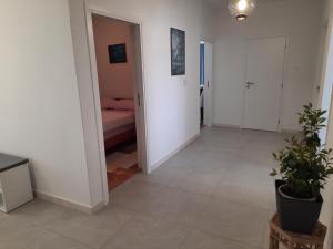 a living room with a bed and a potted plant at Apartments Marijana in Zavalatica