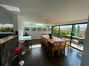 a dining room with a table and chairs and windows at Villa La Laguna in Lajares
