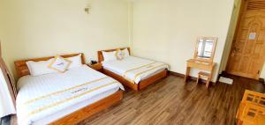 Giường trong phòng chung tại DALAMOON HOTEL