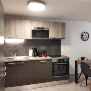 a kitchen with a sink and a stove top oven at ARC 1800 Appartement 6-8 pers,5 cristaux, avec garage in Arc 1800